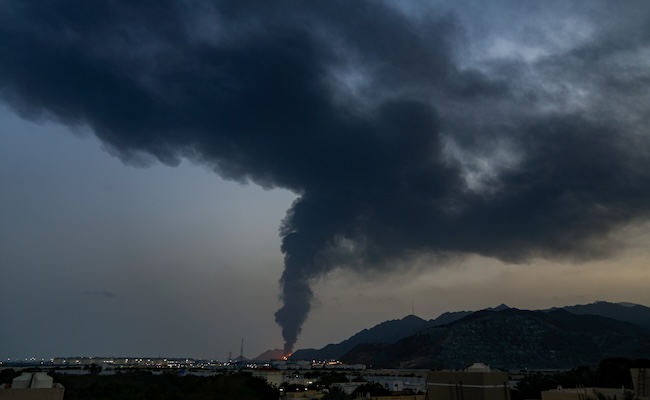Large fire and plume of smoke is visible after, according to the authorities, debris of an Iranian intercepted drone hit the Fujairah oil facility, in Fujairah, United Arab Emirates, Tuesday, March 3, 2026. (AP Photo/Altaf Qadri)