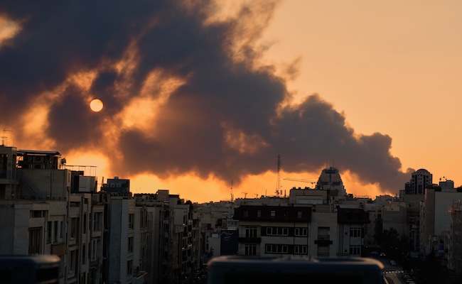 A plume of smoke rises following a U.S.-Israeli military strike in Tehran, Iran, Tuesday, March 3, 2026. (AP Photo/Vahid Salemi)