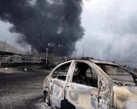 A thick plume of smoke rises from an oil storage facility hit by a U.S.-Israeli strike late Saturday in Tehran, Iran, Sunday, March 8, 2026. (AP Photo/Vahid Salemi)