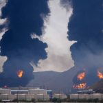 Plumes of smoke and fire rise after debris from an intercepted Iranian drone struck an oil facility, according to authorities, in Fujairah, United Arab Emirates, Saturday, March 14, 2026. (AP Photo/Altaf Qadri)