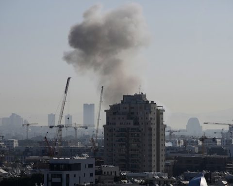 Smoke billows following an Iranian missile strike in Tel Aviv, Tuesday, March 24, 2026. (AP Photo/Ohad Zwigenberg)