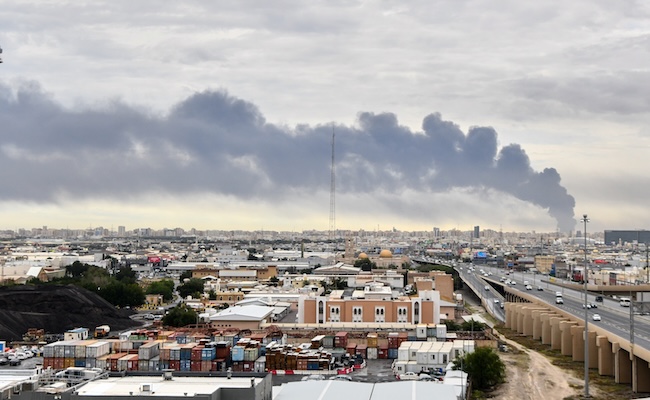 Smoke rises from Kuwait international airport after a drone strike on fuel storage in Kuwait City, Kuwait, Friday, Wednesday, March 25, 2026. (AP Photo)