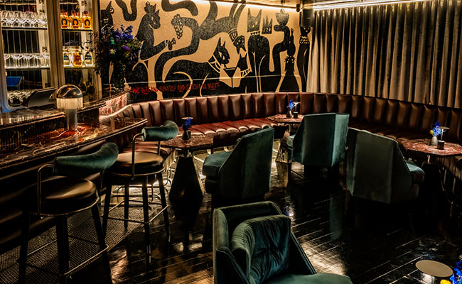 Low light, lacquered surfaces and curved leather seating at Nine Lives’, Rosebank’s restless streets.