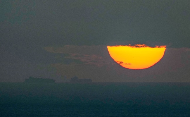 FILE - Ships sail through the Arabian Gulf toward the Strait of Hormuz as the sun sets in the United Arab Emirates Monday, March 23, 2026. (AP Photo, File)