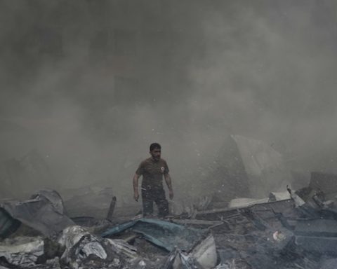 A first responder emerges through the smoke at the site of an Israeli airstrike that struck an apartment building in Beirut, Lebanon, Wednesday, April 8, 2026. (AP Photo/Bilal Hussein)