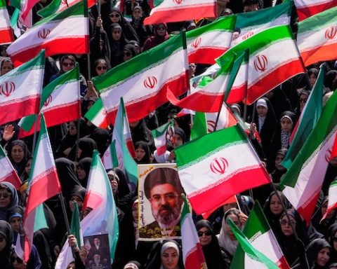 Women hold Iranian flags and a portrait of Supreme Leader Ayatollah Mojtaba Khamenei during a state-organized rally in support of the supreme leader marking National Girl's Day in Tehran, Iran, Friday, April 17, 2026. (AP Photo/Vahid Salemi)