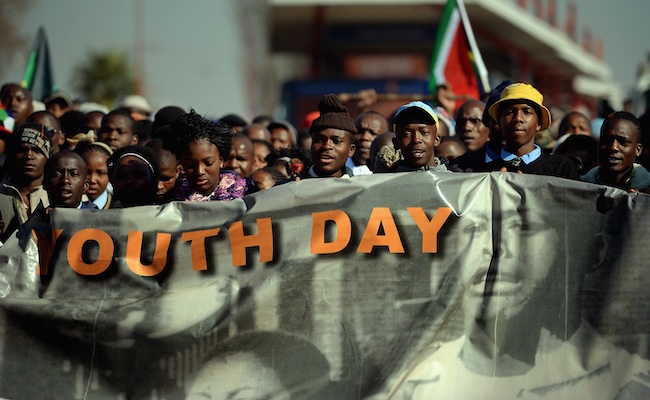 People participate in a march to commemorate Youth Day in Soweto on June 16 2013 in Johannesburg. (Photo by Jeff J Mitchell/Getty Images)