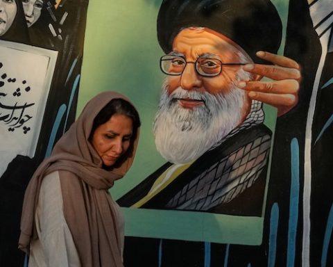A woman walks past a mural depicting a portrait of the late Iranian Supreme Leader Ayatollah Ali Khamenei, who was killed in the U.S. and Israel strike on Feb. 28, in downtown Tehran, Iran, Saturday, July 18, 2026. (AP Photo/Vahid Salemi)